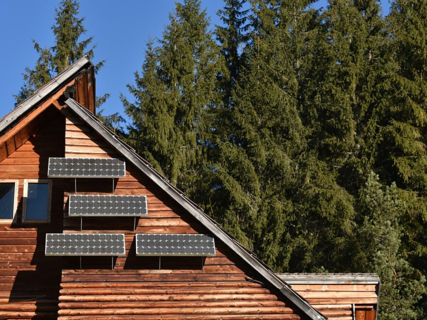 Solar panel on a wooden cottage in the forest